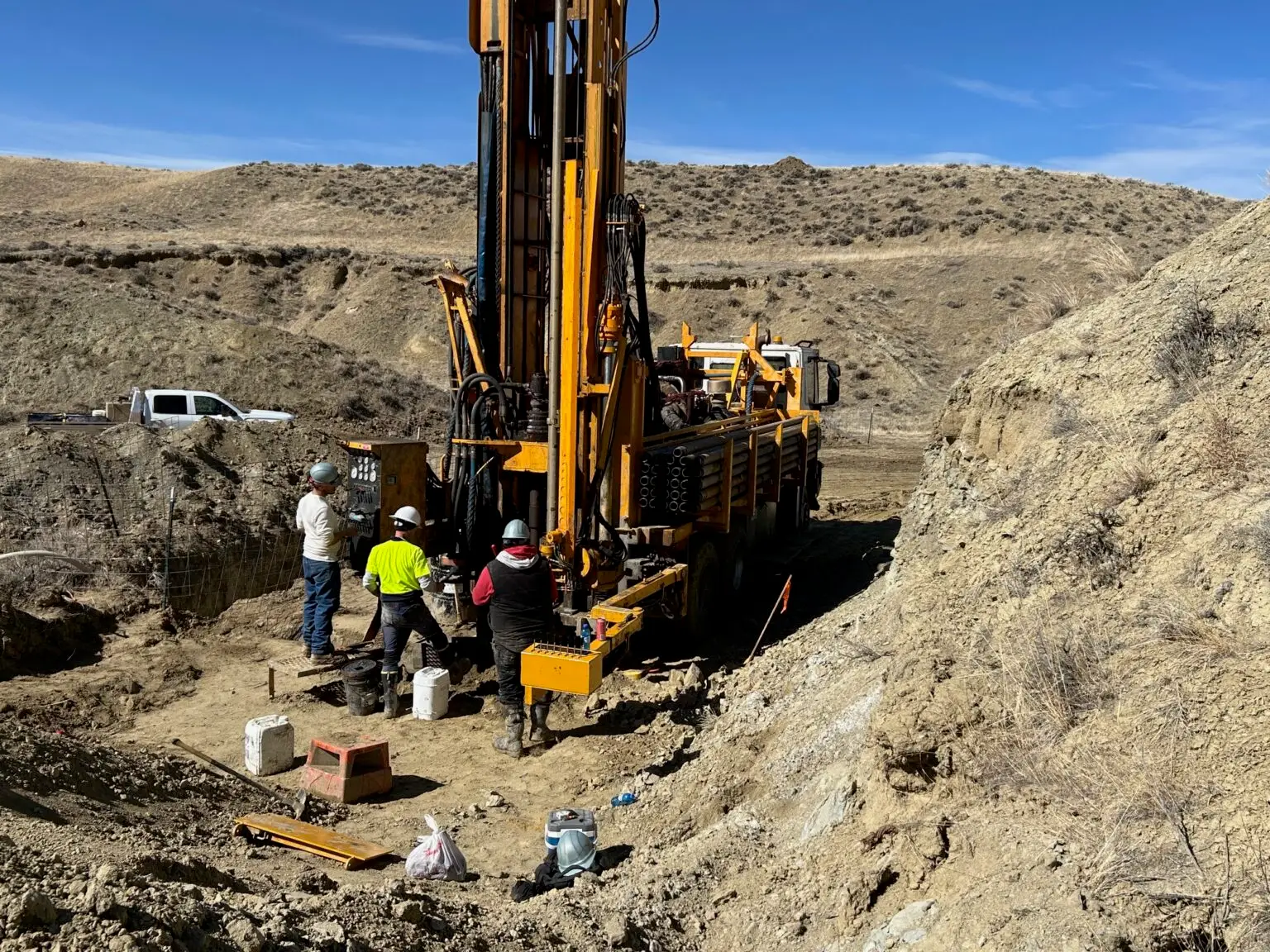 RC drill rig operating on a remote pad in Wyoming with field crew managing collar setup